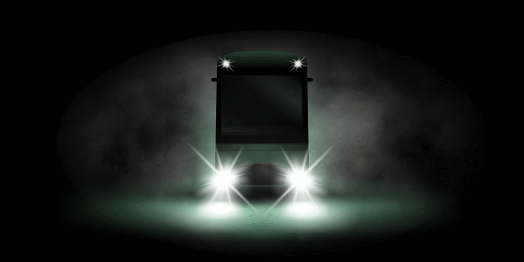 Front view of the Domovago vehicle with headlights shining through fog.