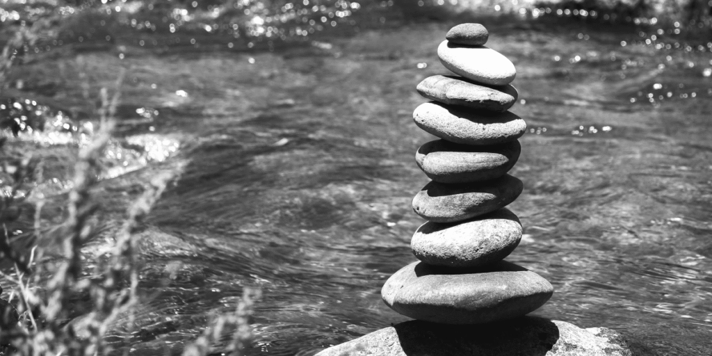 Stack of carefully balanced stones in nature, representing creativity, balance, and the creation of meaning in life.