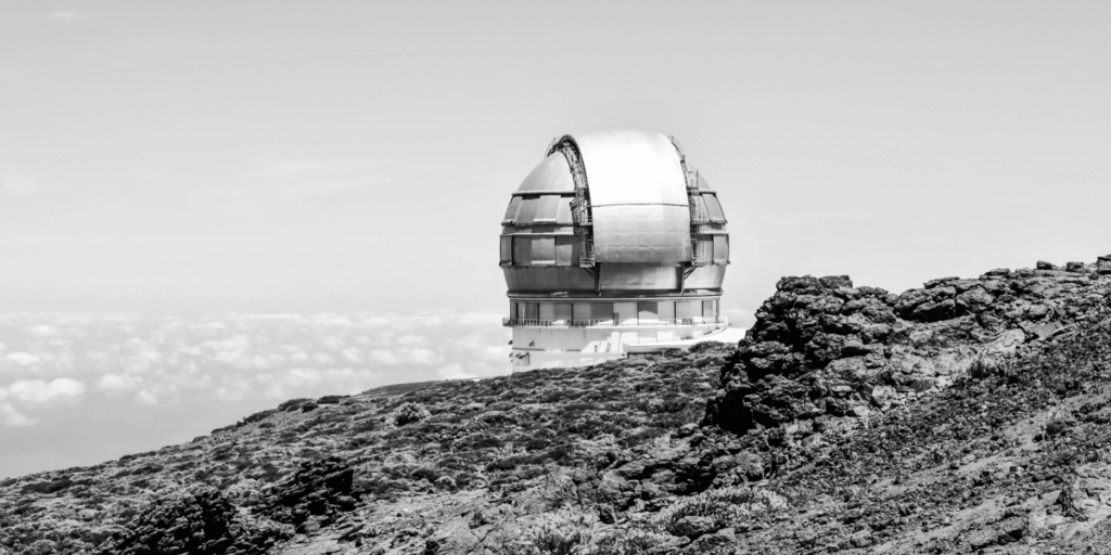 Large astronomical observatory dome on a mountain, looking into the sky as a symbol of exploration and responsibility for the future.