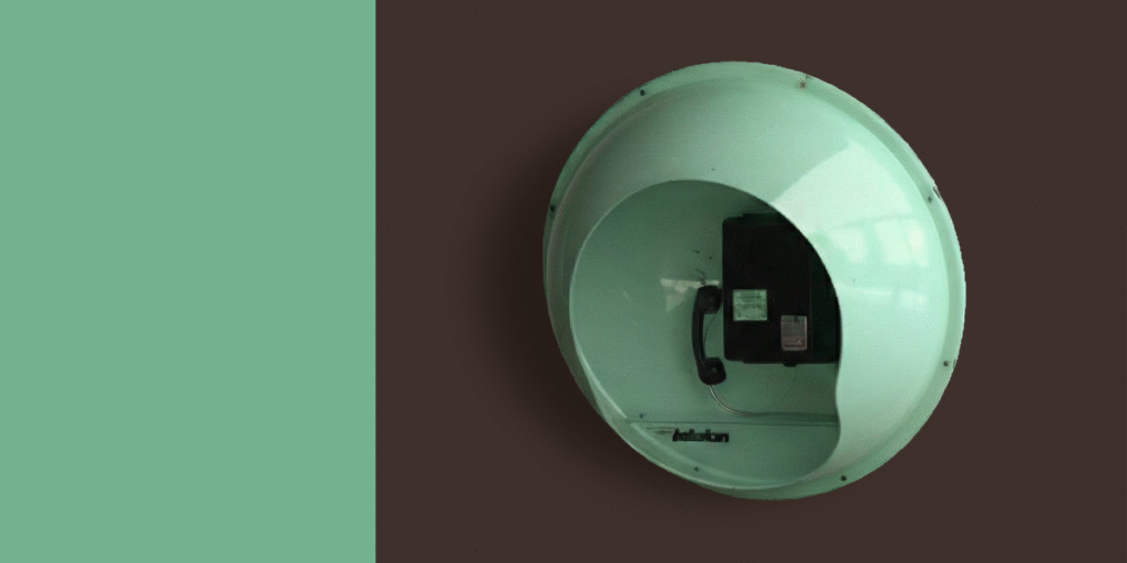 Fiberglass telephone booth designed by Saša Mächtig with a round green shell that isolates the caller and suppresses noise.